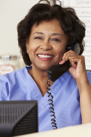 Dental team member smiling while talking on phone
