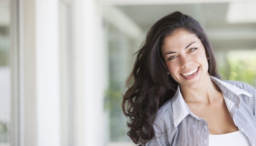 Woman with freckles smiling after cosmetic dentistry in Arundel