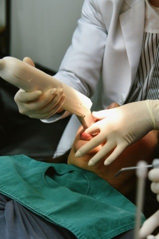 Dentist taking digital dental impressions of a patient's mouth