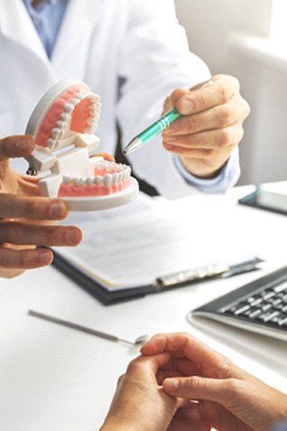 patient talking to dentist about dentures