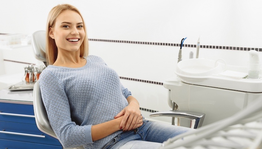 Female Arundel dental patient smiling in dental chair