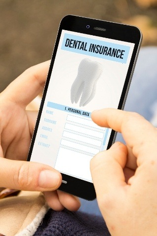 Person filling out dental insurance form on their phone