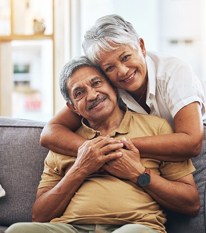 An older woman admiring her new dental implant