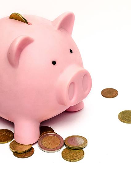 Pink piggy bank and loose coins
