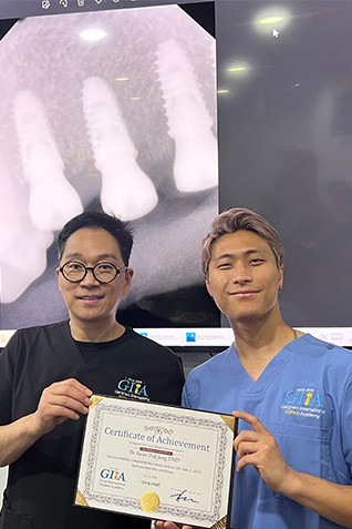 Dr. Jung and another dentist holding degree