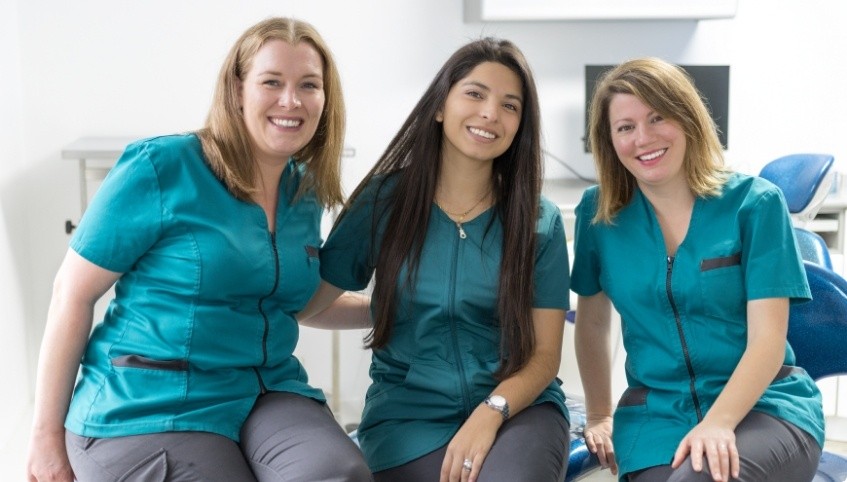 Three smiling dental team members in Arundel