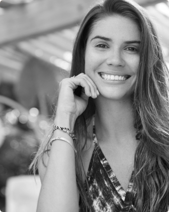 Smiling young woman in sleeveless top with two bracelets on her wrist