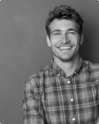 Young man in plaid shirt grinning