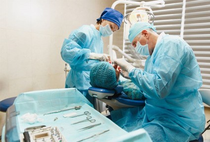 Dental team performing oral surgery