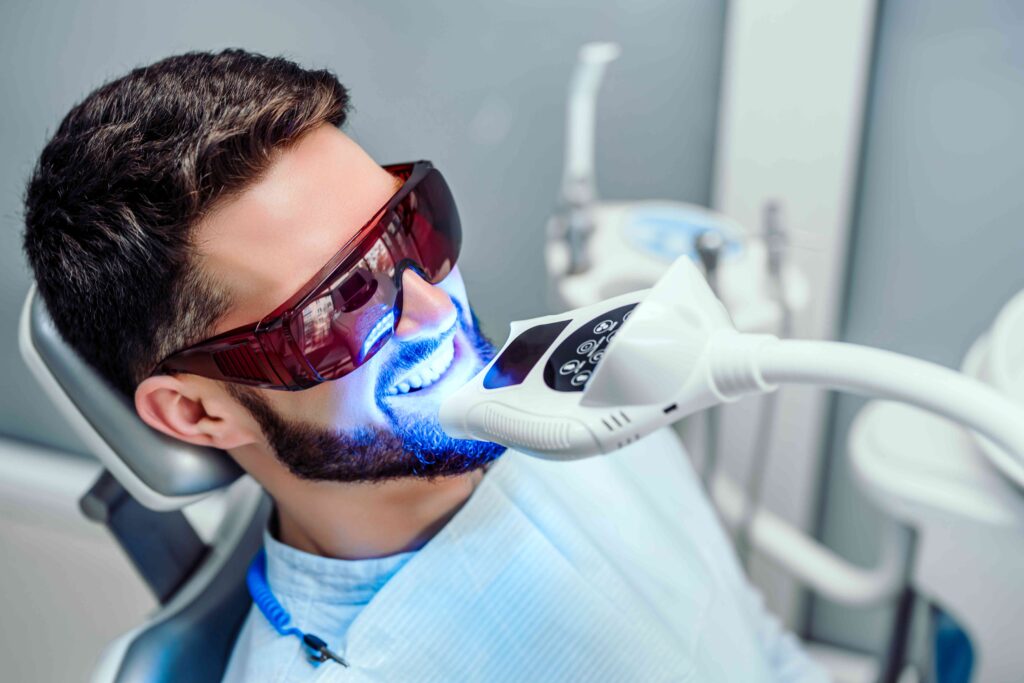 Man whitening his tooth