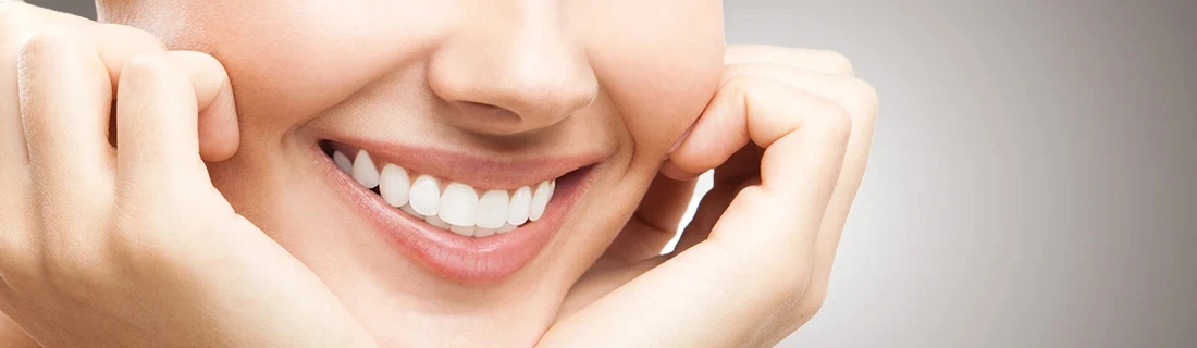 Dentist Arundel ME A Close Up of a Woman Smiling with Her Head Cradled in Her Hands Our Services A Close Up of a Woman Smiling with Her Head Cradled in Her Hands